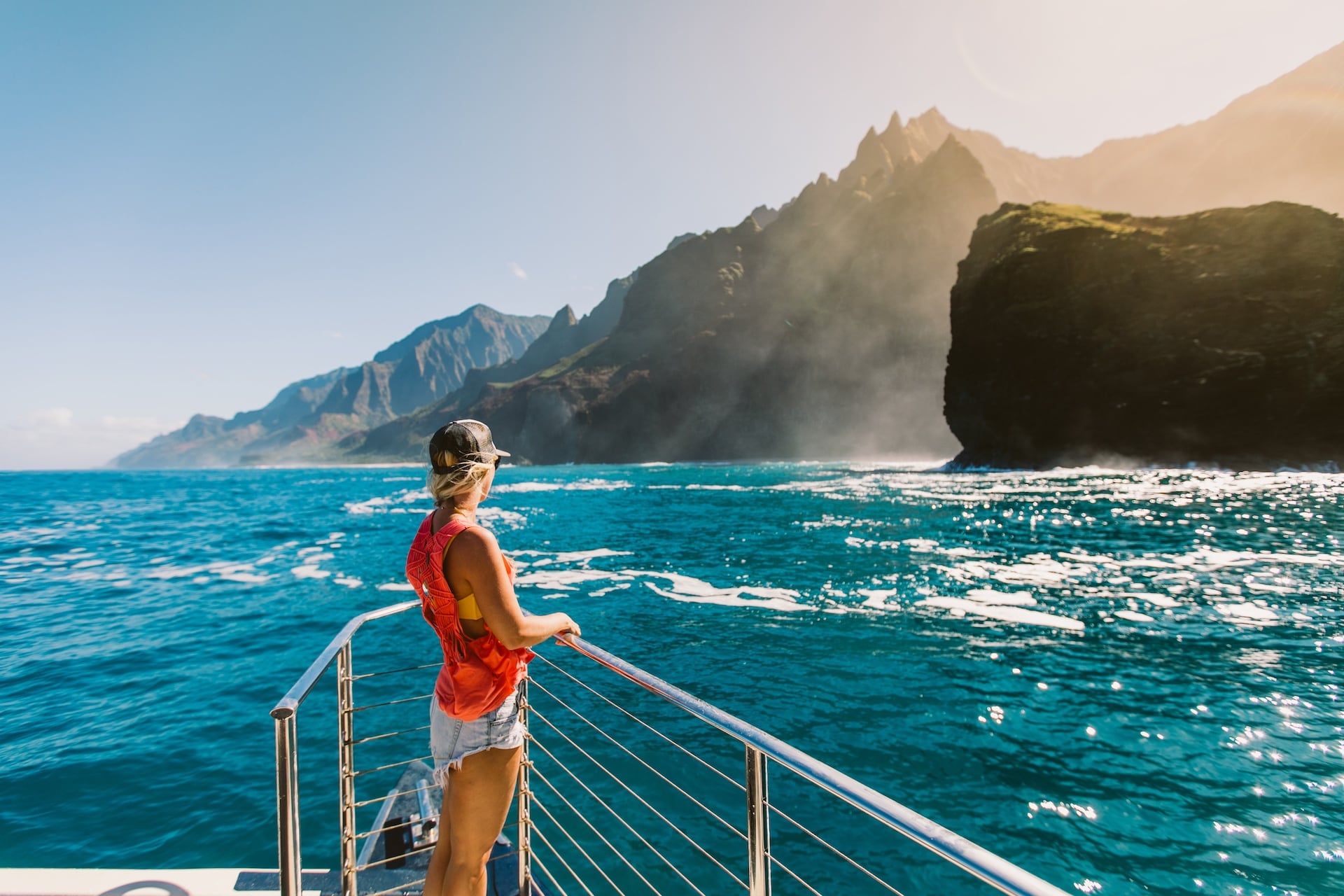 Woman enjoying the stunning coastal scenery from the deck of Captain Andy's yacht